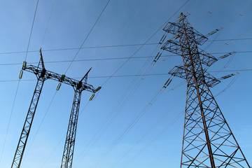 Power transmission towers against the blue sky