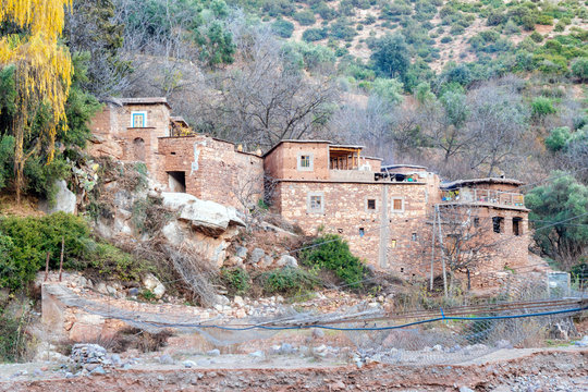Berber village by river in Atlas mountains, Morocco