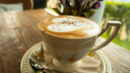 cup of coffee on wooden table. Cup of hot latte art coffee. Caffeine, chocolate. Latte art coffee over wooden background