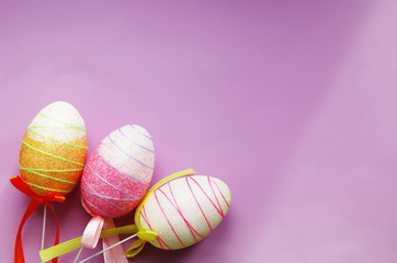 decorative Easter eggs on purple background