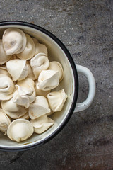 tortellini with filling (ravioli dumplings) menu concept. food background. top view. copy space