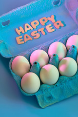 Happy easter lettering and easter eggs composition on festive blue background