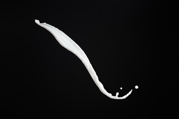 fresh white milk splash with drops isolated on black