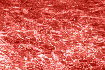 Obraz premium Red coral color background. Water pattern, abstract background