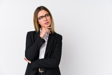 Young business caucasian woman looking sideways with doubtful and skeptical expression.