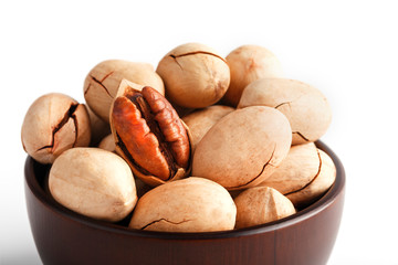 Pecan in a wooden Cup isolated on a white background. Isolate.