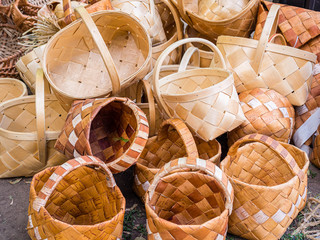 A bunch of wicker baskets in retro style. Heap of birch baskets. Pile of birch bark bast baskets.