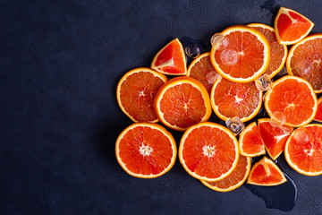 Fresh red orange or grapefruit with ice on a blue classic background. Tropical citrus fruit....