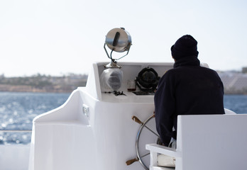 Steersman managing the ship in the Red Sea