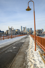 city skyline over river bridge