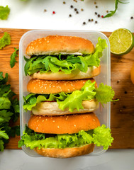 School lunch. Food Box with a delicious burger. Top view.