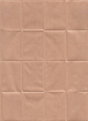 Folded Kraft paper texture. Seamless pattern with a folded and stretched kraft paper texture.