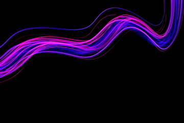 Long exposure light painting, vibrant purple color in abstract swirl against a clean black background.  Light painting photography.