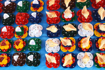 sea snail shell decoration on colorful paper flower.