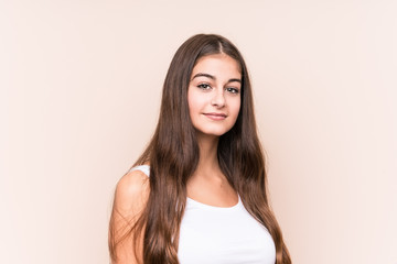 Young cute caucasian woman against a beige background