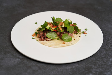 Pork carnitas street tacos, close-up. Mexican tacos with beef, tomatoes, avocado, chilli and onion