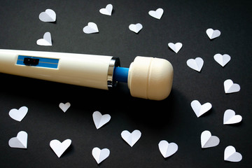 Sex toy. White vibrator on a black background. Massager vibrator, magic wand vibrator. Useful for...