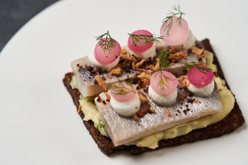Smorrebrod with Baltic herring fish, smoked mousse, close-up