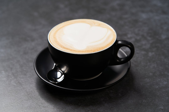 Cup Of Coffee Latte With Foam, Close-up. Black Cup Of Cappuccino