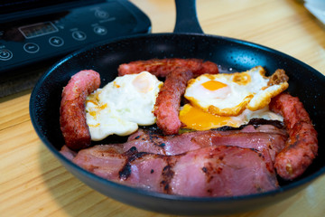 Healthy breakfast on a black pan in the kitchen