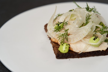 Smorrebrod with fried chicken, fennel and tarragon. Toasted bred with chicken