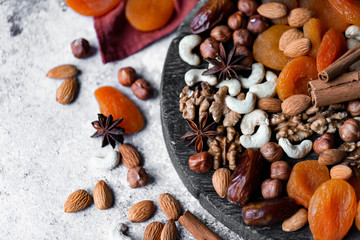 Natural healthy and delicious vegan dessert. Concept of sweet, low calories and tasty snack. Dry fruits and spices. Wooden dark rustic board, neutral background. Close up, macro 