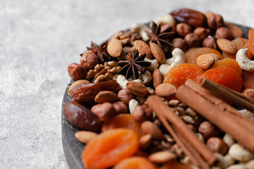 Natural healthy and delicious vegan dessert. Concept of sweet, low calories and tasty snack. Dry fruits and spices. Wooden dark rustic board, neutral background. Close up, macro 