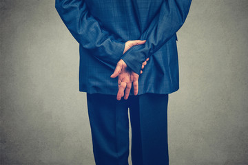 Swearing an oath with fingers crossed behind the back