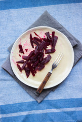 Dirty unclean dishes with traces and pieces of food. Kitchenware. Finished lunch food. Beetroot salad