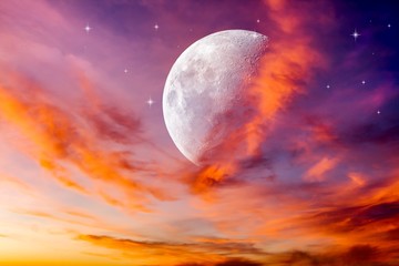 Moon in bright clouds of sunset sun . New moon .  The sky at night with stars. 