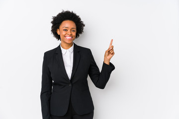 Middle aged african american business  woman against a white background isolated smiling cheerfully pointing with forefinger away.