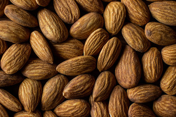 Fototapeta premium Whole organic almond nuts top view