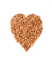 Heart shape made from lentils on a white background.