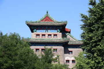 Archery Tower of Zhengyangmen behind trees on a summer day, Beijing (China)