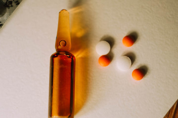 Ampoule with serum, pills and blisters. Pharmaceutical business wallpaper. Medical care. Vitamins...
