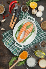 Grilled salmon filet steak with aromatic herbs, spices and vegetables. Seafood. Cooking concept. Culinary background. Table background menu. Copy space