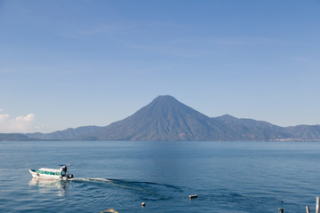Lake Atitlan, Guatemala with the San Pedro volcano - Motorboat on the lake - sunrise in Panajachel