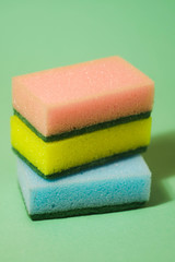 Colored sponges for cleaning on blue background. Copy space. Dish washing concept. Cleaning set background. 