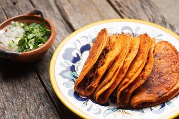 Mexican beef barbacoa tacos on wooden background