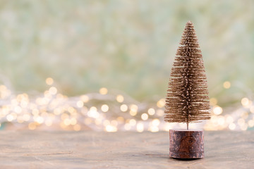 Colorful Christmas tree on green, bokeh background.