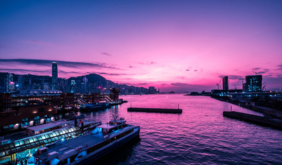 Victoria Harbour and HongKong skyline with sunset sky -