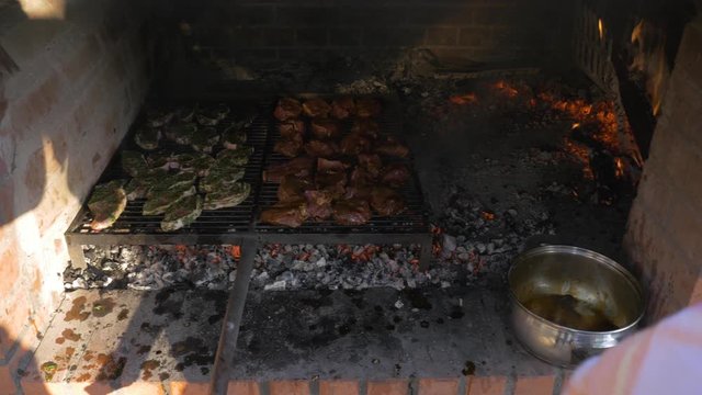Steaks Cooking Inside Outdoor Stone Oven