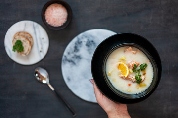 Traditional Finnish salmon soup  Lohikeitto with potato, creme and lemon