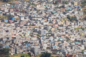 Many residential houses in Quito, Ecuador. Photo taken from a hill with telephoto lens