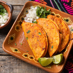 Mexican beef barbacoa tacos on wooden background