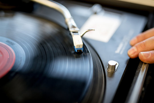 closeup of a record player and hand