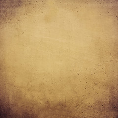 A concrete time aged wall with a textured scratched surface