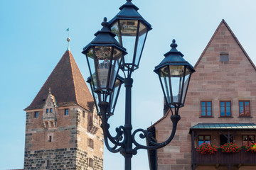 The beautiful lamppost in traditional Bavarian style near the building in the old city in Nuremberg, Bavaria, Germany