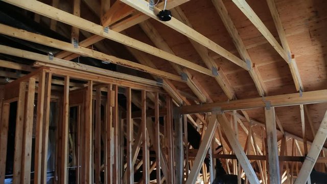 The frame of a wooden house on a unfinished object in close up a new house under contruction frame