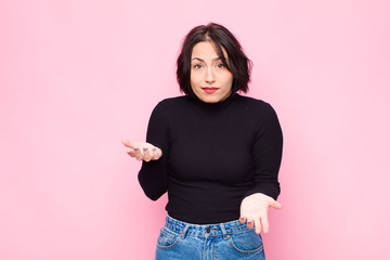 young pretty woman feeling clueless and confused, not sure which choice or option to pick,...